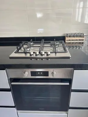 a stove top oven sitting in a kitchen at Appartement luxueux à Fès in Douar Oulad Mhammed