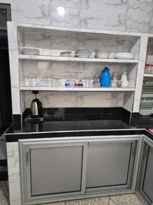 a kitchen with a counter top with dishes on it at Apparemment familiale 110 m2 in MeknèsKatine