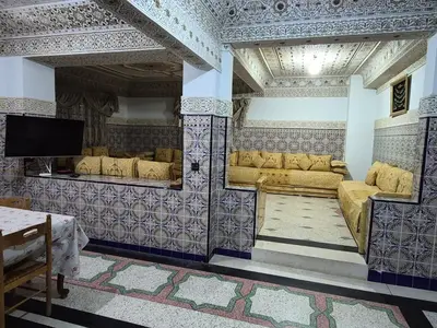 a living room with couches and a flat screen tv at Apparemment familiale 110 m2 in MeknèsKatine