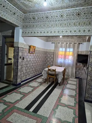 a room with a table and a ceiling with tiles at Apparemment familiale 110 m2 in MeknèsKatine