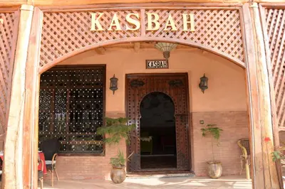 an entrance to a restaurant with a sign above the door at Kasbat Dar diafa Tourbist in Kalaat MGouna