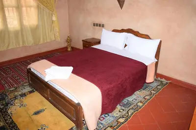 a bedroom with a large bed in a room at Kasbat Dar diafa Tourbist in Kalaat MGouna