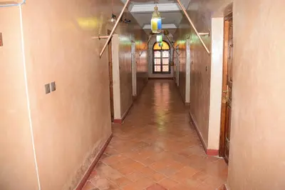 an empty hallway in a building with a long corridor at Kasbat Dar diafa Tourbist in Kalaat MGouna