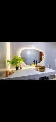 a bathroom with a sink and a mirror at Villa wafai in Srarhna