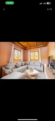 a living room with a couch and a table at Villa wafai in Srarhna