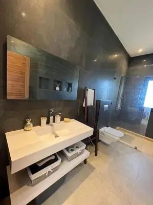 a bathroom with a sink and a toilet at Villa Mia, Piscine chauffée, parking,Iptv in Najem