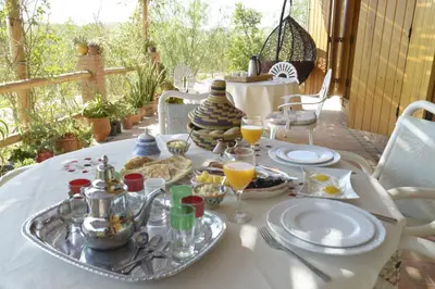 a table with a tray of food and drinks on it at Guest farm Oulad Chmicha in Bir el Kelb