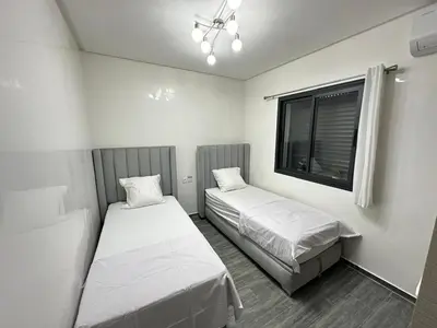 two beds in a small room with a window at Appartement Moderne & Cosy in Fès