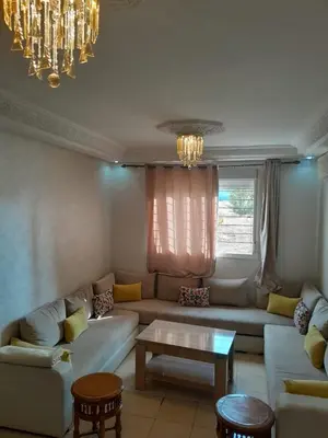 a living room with a couch and a table at Marwan's apartment 2 in Ifrane