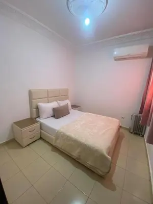 a bedroom with a bed and a light on the ceiling at Marwan's apartment 2 in Ifrane