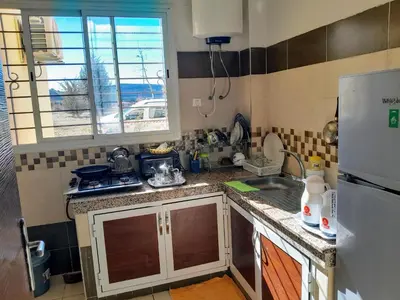 a small kitchen with a sink and a refrigerator at Marwan's apartment 2 in Ifrane