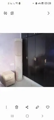 a bathroom with black cabinets and a trash can at واد فاس in Douar Trhaïtia