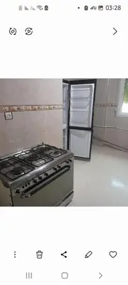 a kitchen with a stove and a refrigerator at واد فاس in Douar Trhaïtia