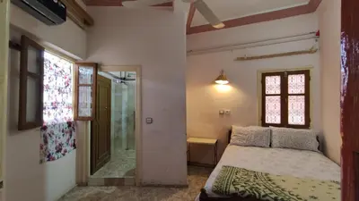 a small bedroom with a bed and a window at Hotel Oasis Tinghir in Tinerhir