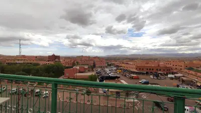 a view of a city with cars parked in a parking lot at Hotel Oasis Tinghir in Tinerhir