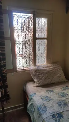 a bedroom with a bed and a window at Hotel Oasis Tinghir in Tinerhir