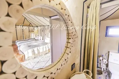 a mirror in a room with two beds at Merzouga VIP Luxury Camp in Merzouga