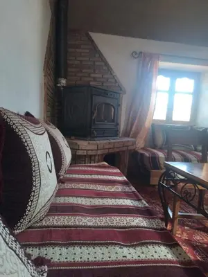 a living room with a couch and a fireplace at erg sahara merzouga in Ouzina