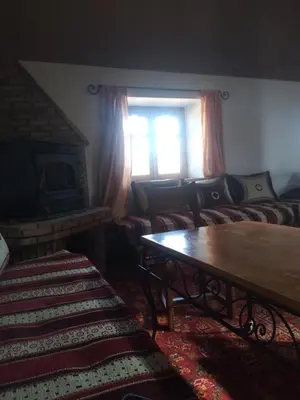 a living room with a couch and a window at erg sahara merzouga in Ouzina