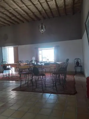 a dining room with a table and chairs at erg sahara merzouga in Ouzina