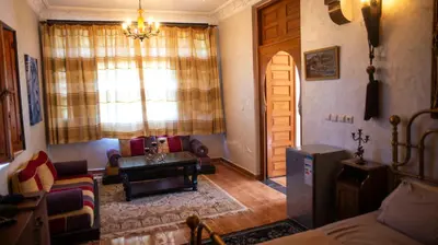 a living room with a couch and a table and a window at Extrait d'atlas in Tafza