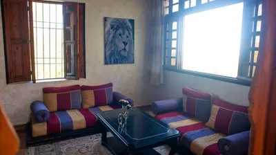 a living room with a couch and a table at Extrait d'atlas in Tafza