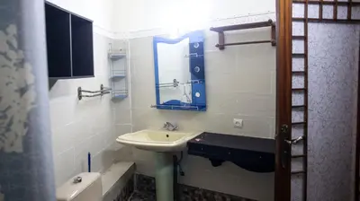 a bathroom with a sink and a mirror at Extrait d'atlas in Tafza