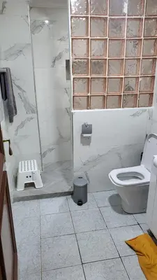 a bathroom with a toilet and a glass shower at Votre havre de paix à Ifrane in Ifrane