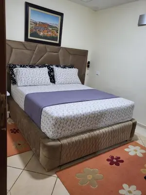 a bedroom with a large bed with a brown headboard at Votre havre de paix à Ifrane in Ifrane