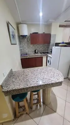 a kitchen with a counter top and a kitchen with a refrigerator at Votre havre de paix à Ifrane in Ifrane