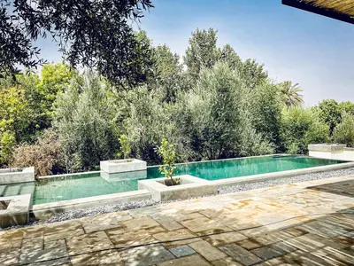 a swimming pool with trees in the background at CASA ULIVO villa en pleine nature in Dar Caïd Bou Driss
