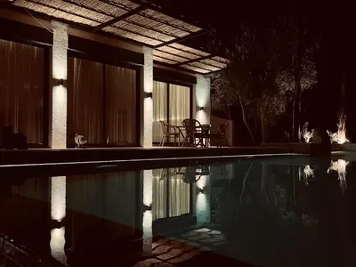 a house with a swimming pool at night at CASA ULIVO villa en pleine nature in Dar Caïd Bou Driss