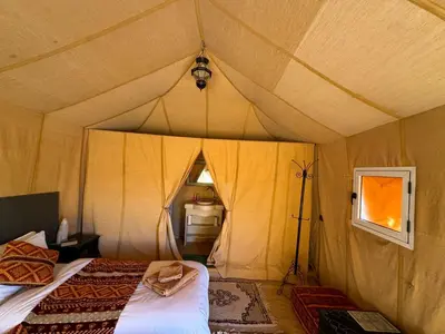 a room with two beds in a tent at hagra luxury camp Merzouga in Merzouga