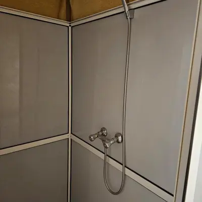 a shower in a bathroom with a hose at hagra luxury camp Merzouga in Merzouga