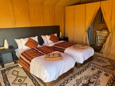 a bedroom with two beds with towels on them at hagra luxury camp Merzouga in Merzouga