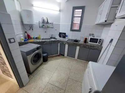 a small kitchen with a washing machine and a microwave at New feeling maison climatisée in Ville Nouvelle