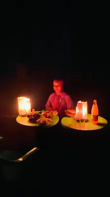 a man sitting at a table with two plates of food at Youssef Rezki Taghia in Taghia