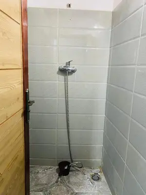 a shower with a hose in a bathroom at Youssef Rezki Taghia in Taghia