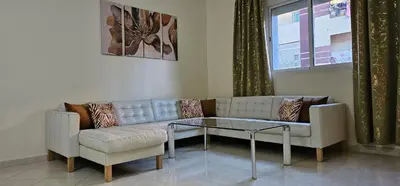 a living room with a couch and a glass table at Diar Kamiliya Meknès in Meknès