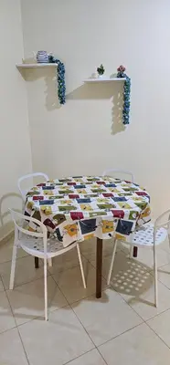 a table with chairs and a quilt on it at Diar Kamiliya Meknès in Meknès