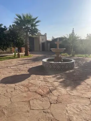 a fountain in the middle of a stone courtyard at Luxury Villa With Large Private Pool in Marrakech