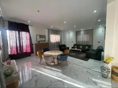 a large living room with a table and chairs at Luxury Villa With Large Private Pool in Marrakech
