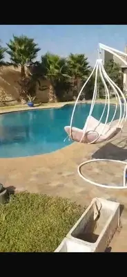 a swing in front of a swimming pool at Luxury Villa With Large Private Pool in Marrakech