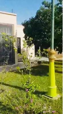 a yellow pole in the grass next to a street light at Luxury Villa With Large Private Pool in Marrakech