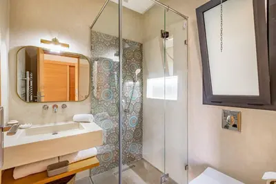 a bathroom with a sink and a shower at villa Zina, Élégance et luxe,piscine & jacuzzi in Marrakech