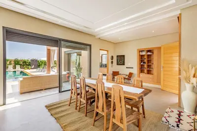 a dining room with a table and chairs at villa Zina, Élégance et luxe,piscine & jacuzzi in Marrakech