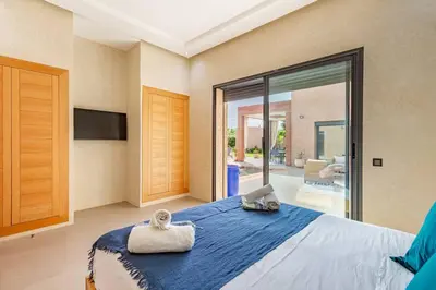 a bedroom with a large bed with two towels on it at villa Zina, Élégance et luxe,piscine & jacuzzi in Marrakech