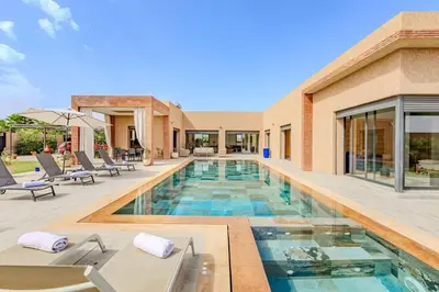 a swimming pool in the middle of a house at villa Zina, Élégance et luxe,piscine & jacuzzi in Marrakech