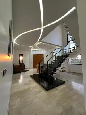 a living room with a staircase in a house at Elite Villa on the Road to Fes in Marrakech