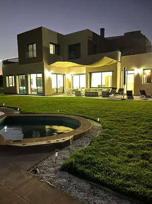 a large house with a pool in the yard at Elite Villa on the Road to Fes in Marrakech